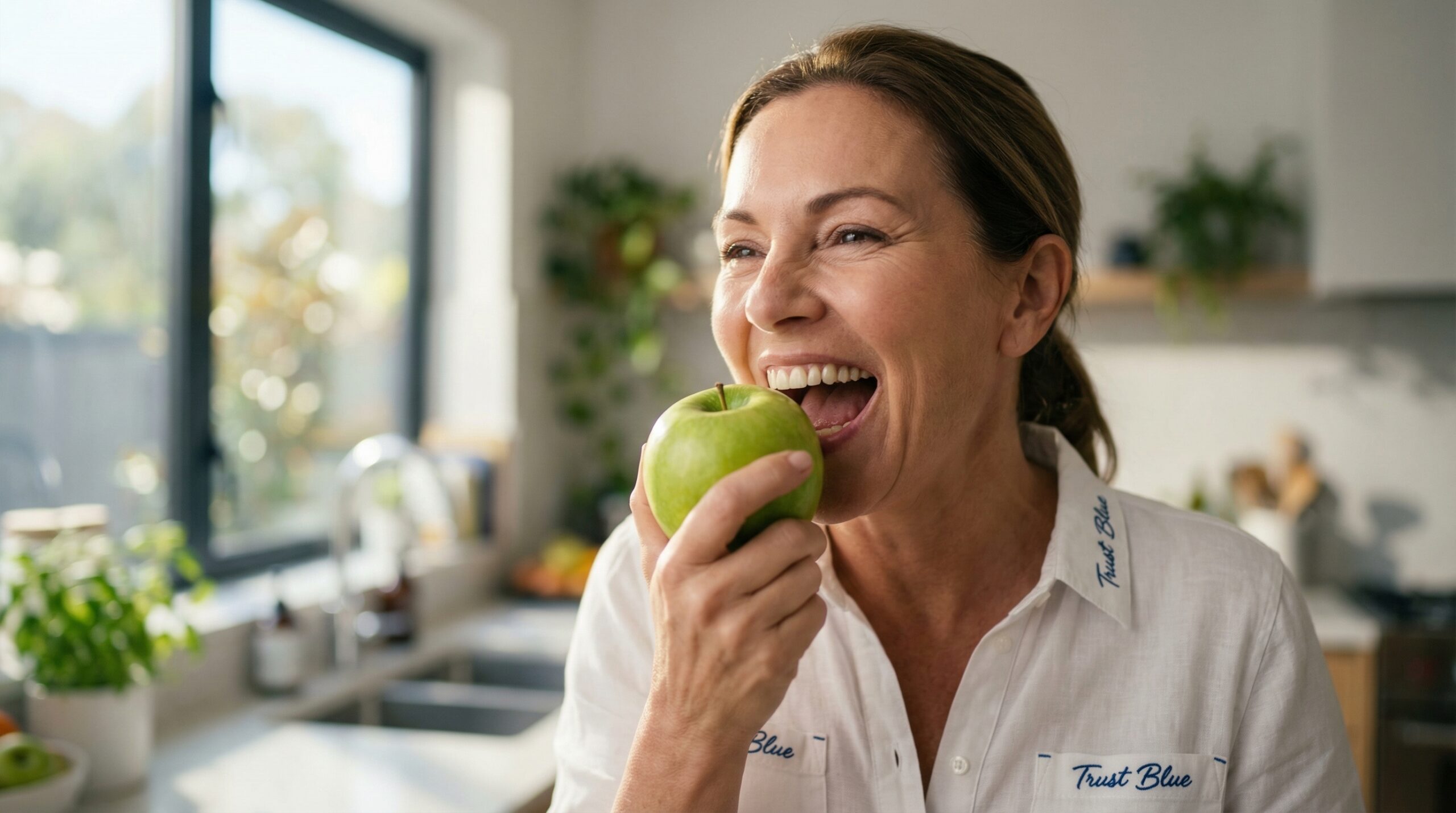 Woman biting into an apple with restored teeth